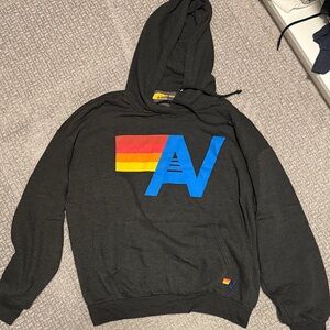 Aviator Nation Black Hoodie with Blue 'A' and Red-Orange-Yellow Stripe Logo